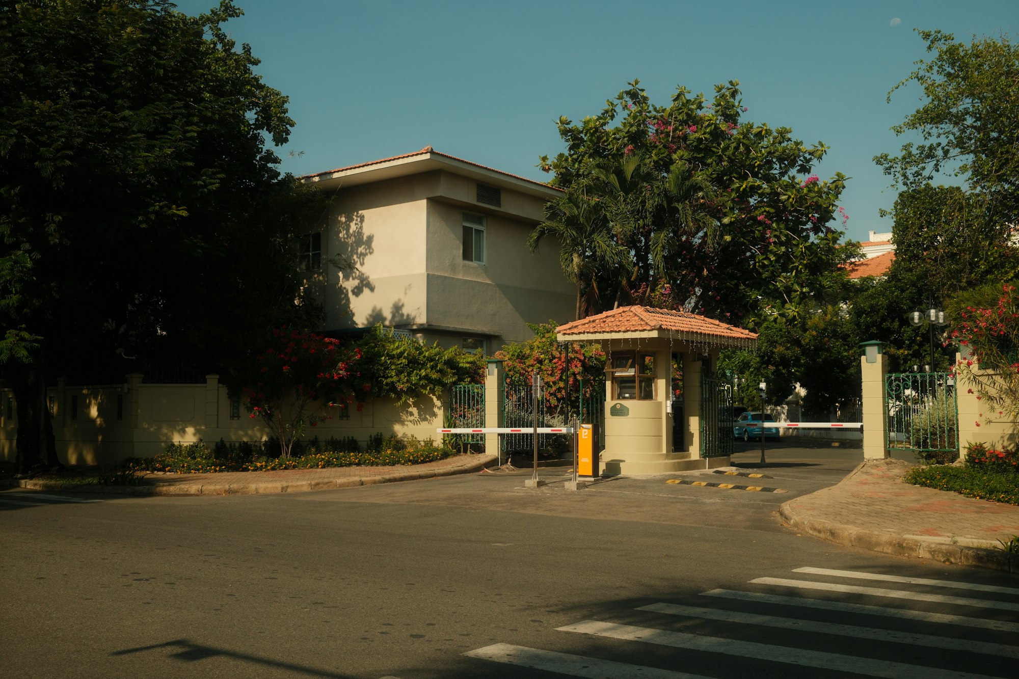 A private estate's manned security gatehouse with barrier